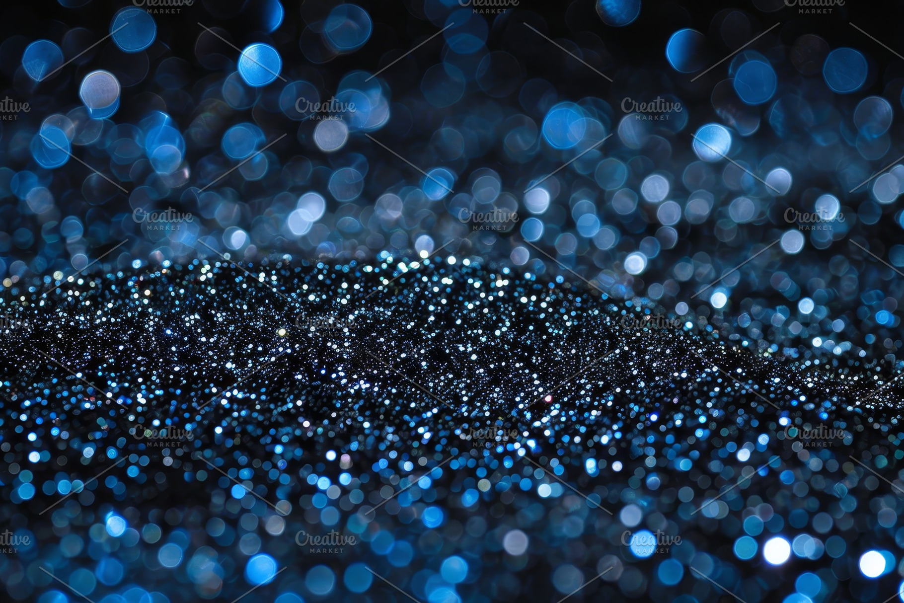 Tiny blue and silver particles shimm, a Photo by Tanuart