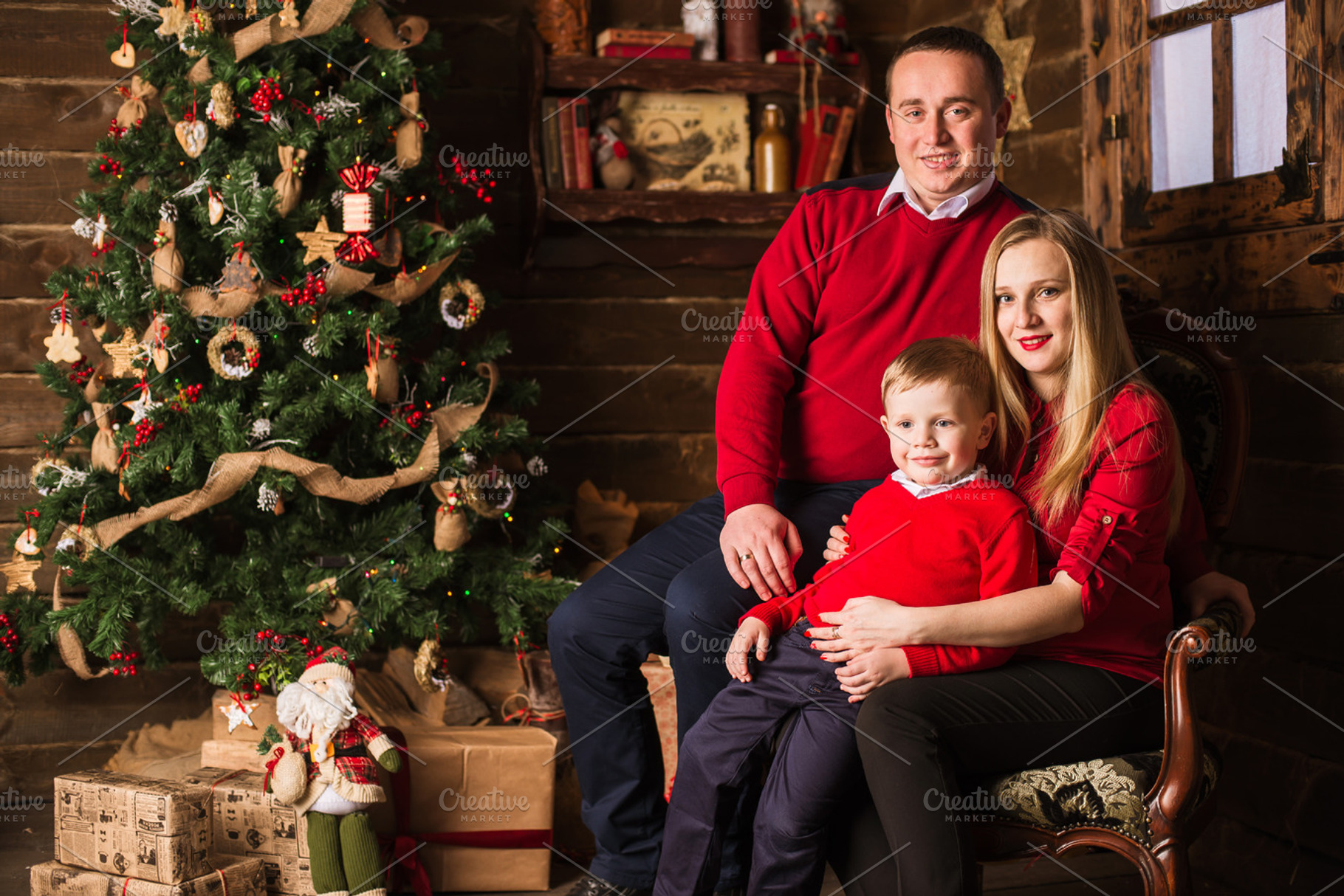 Young pregnant mother, father and small son celebrating Christmas at home, a Holiday Photo by BodiaPhoto