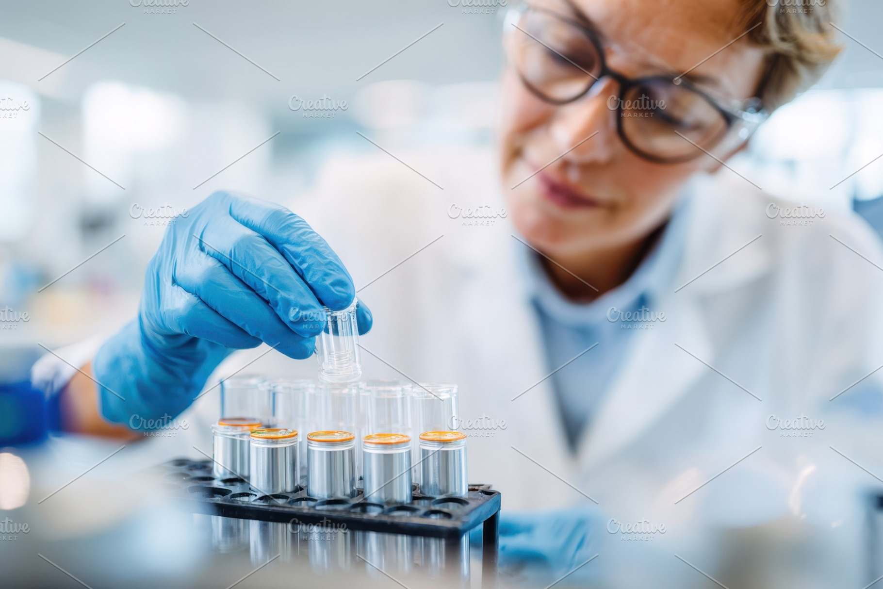 Scientist handling test tubes in laboratory, a Health & Medical Photo by AlyaAnd