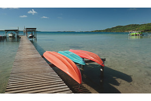 Colorful kayaks resting on a, a Nature Photo by Goinyk