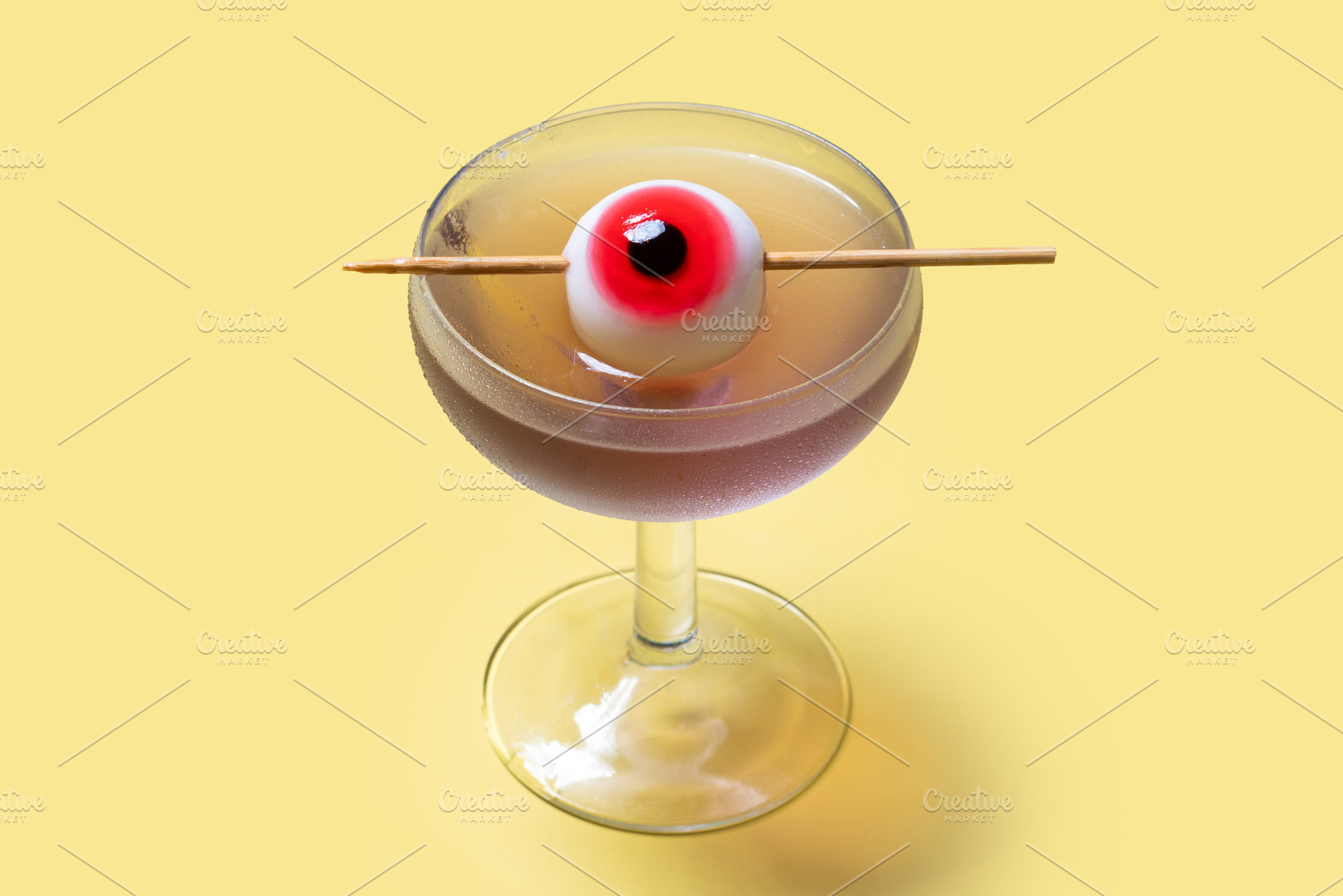 Purple Halloween cocktail garnished with candy eye, a Food & Drink Photo by etorres69