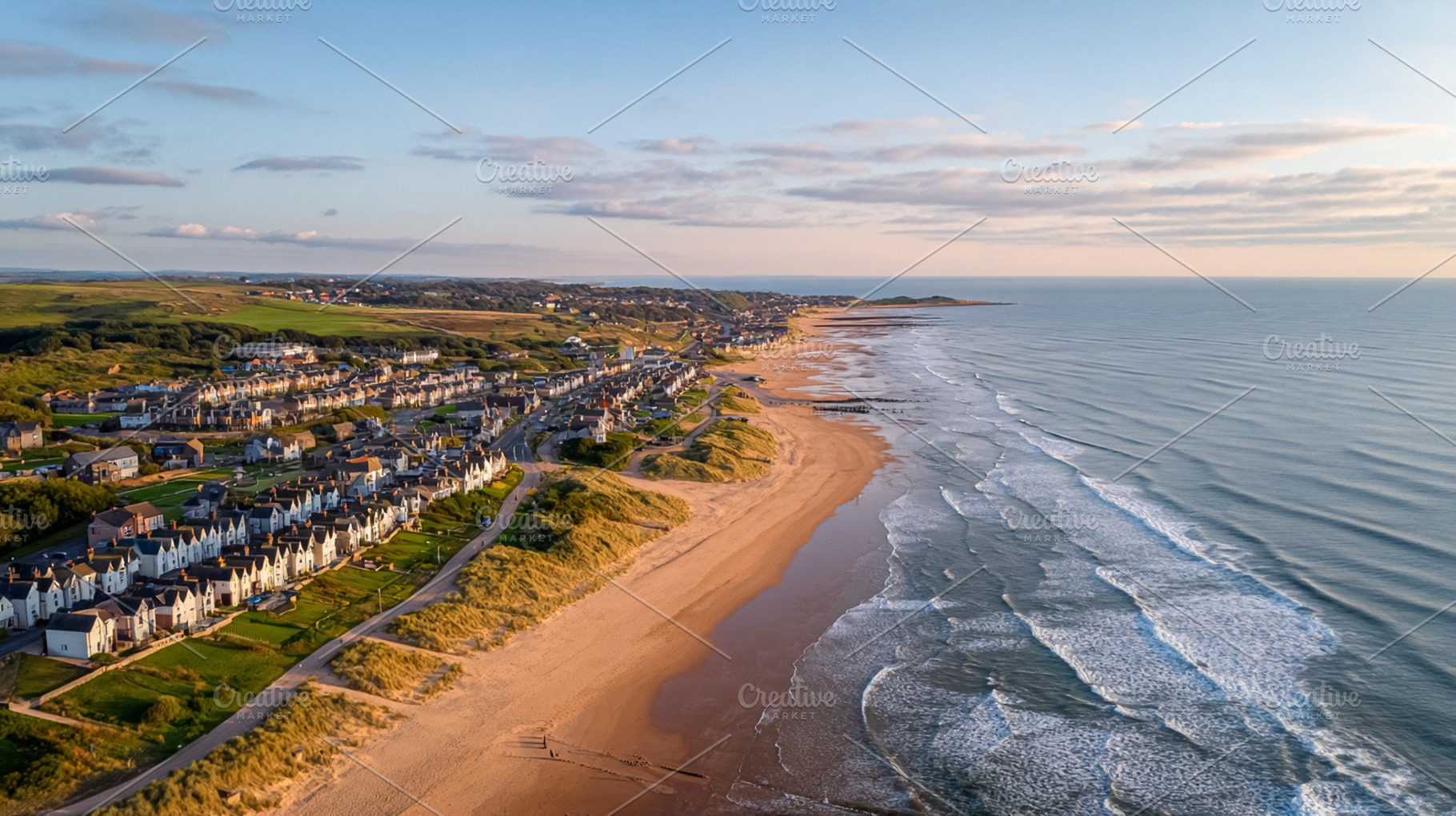 Coastal town houses lining a vast sandy beach at sunset, with wa, a Photo by Studio ANNA