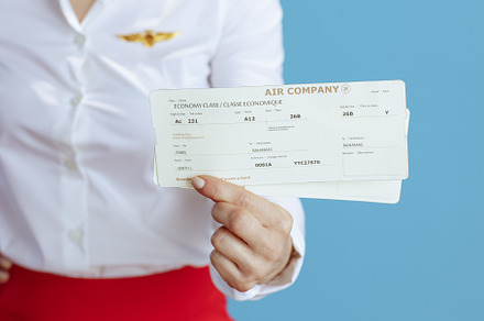 Closeup on elegant air hostess woman on blue, a Business Photo by Alliance Images