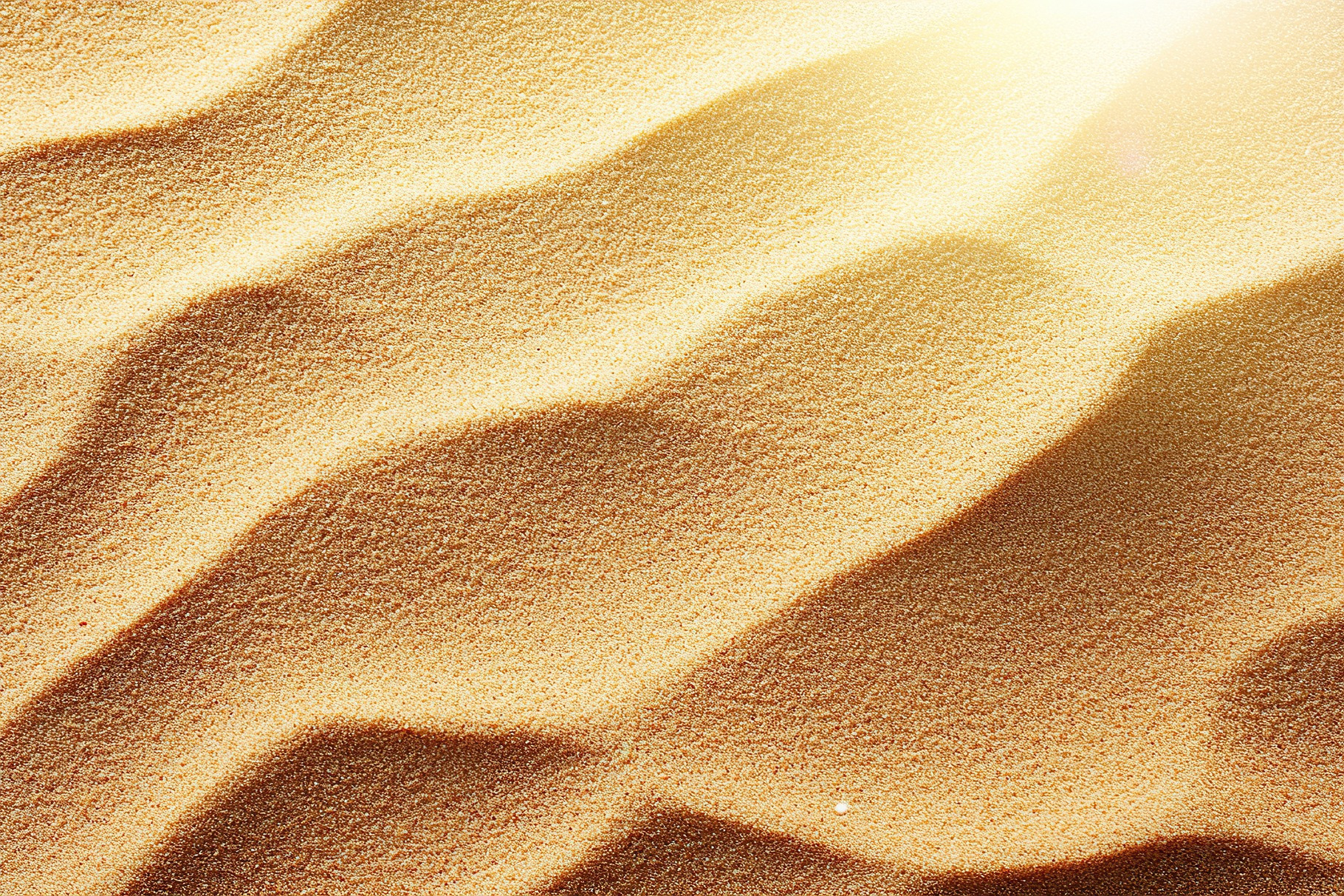 Patterns of clean and smooth sand surface illuminated by sunlight in a ...