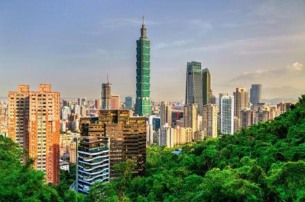 Modern skyline of Taipei, Taiwan seen from a green hill under blue sky, an Architecture Photo by Leonid Andronov