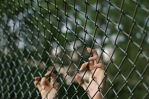 Trapped containing fence, child, and hands