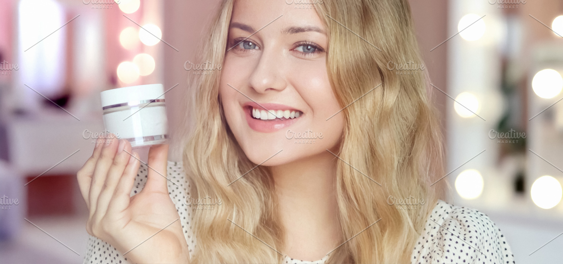 Blonde woman smiling, holding white beauty product jar, presenti, a Person Photo by Anneleven