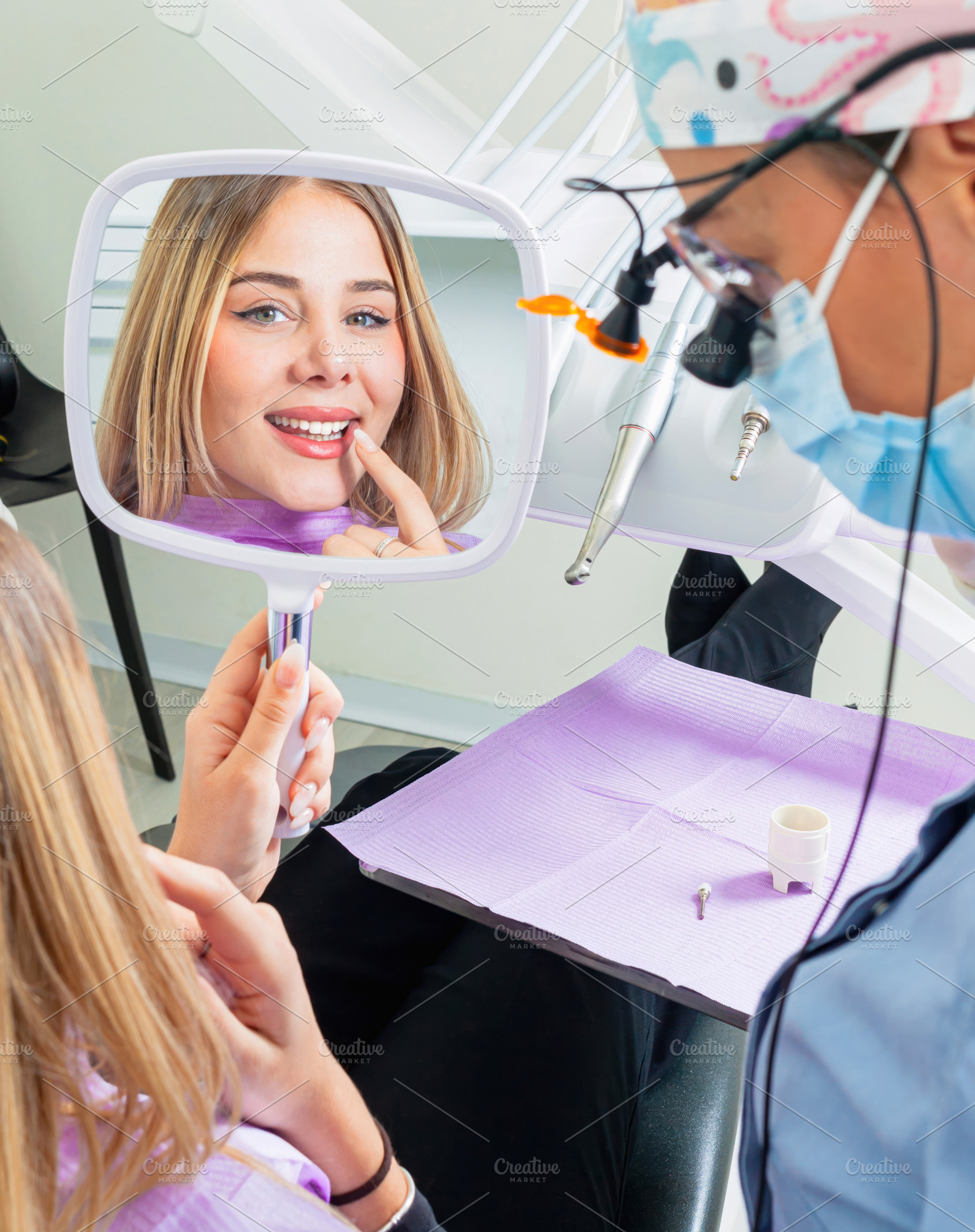 Young woman admiring her smile after dental procedure, a Health & Medical Photo by Antonio Gravante Market