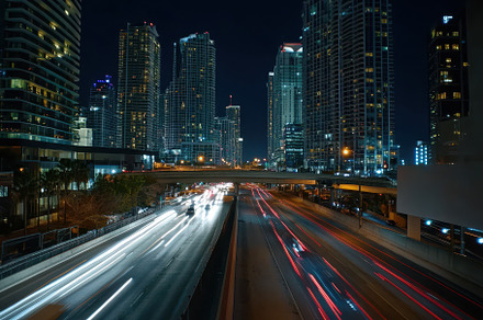 Nighttime traffic flows over a bridg, a Photo by Iftikhar Alam