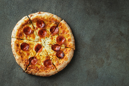 A slice of hot Italian pizza with stretching cheese. Pizza pepperoni on a dark, a Food & Drink Photo by Budarinphoto