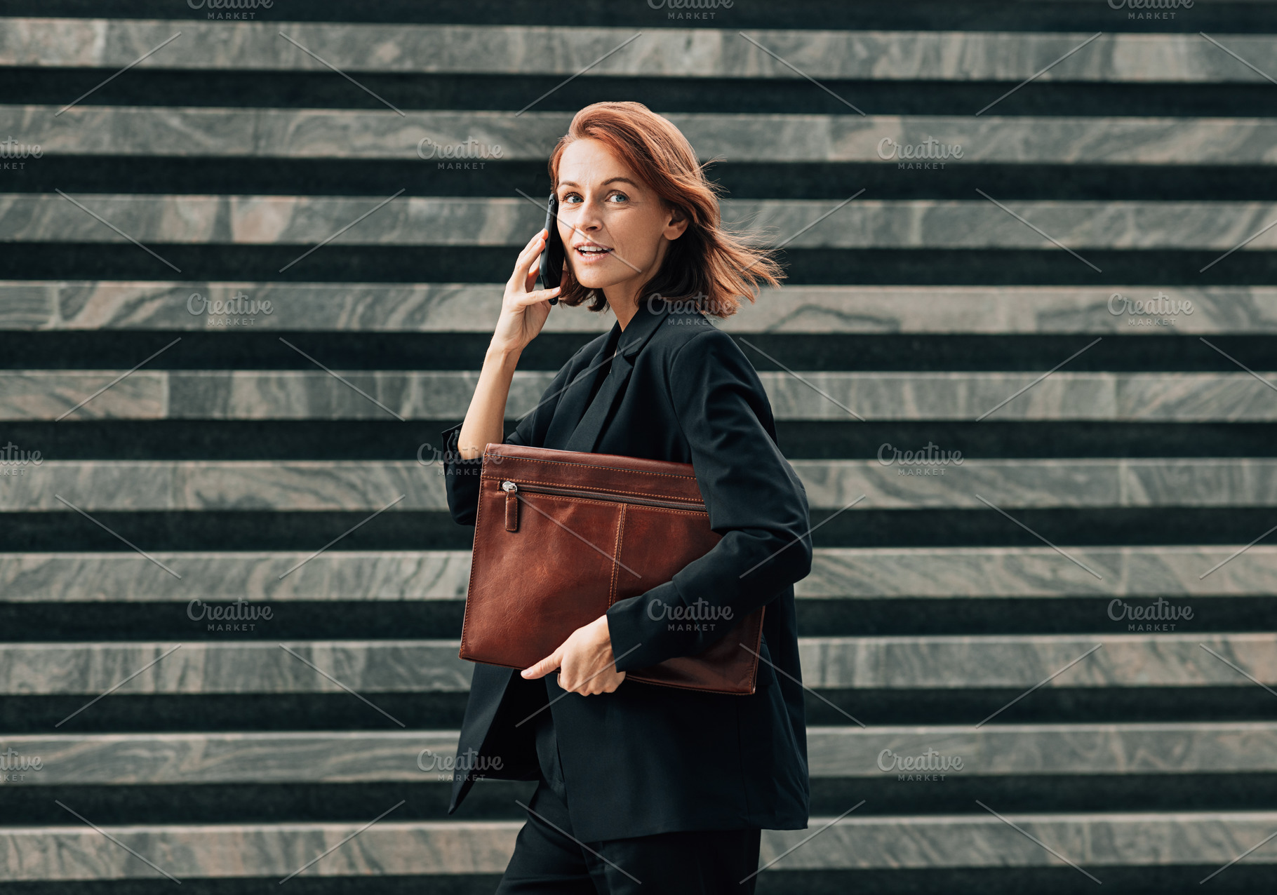Smiling and busy female in black, a Business Photo by Artem Varnitsin