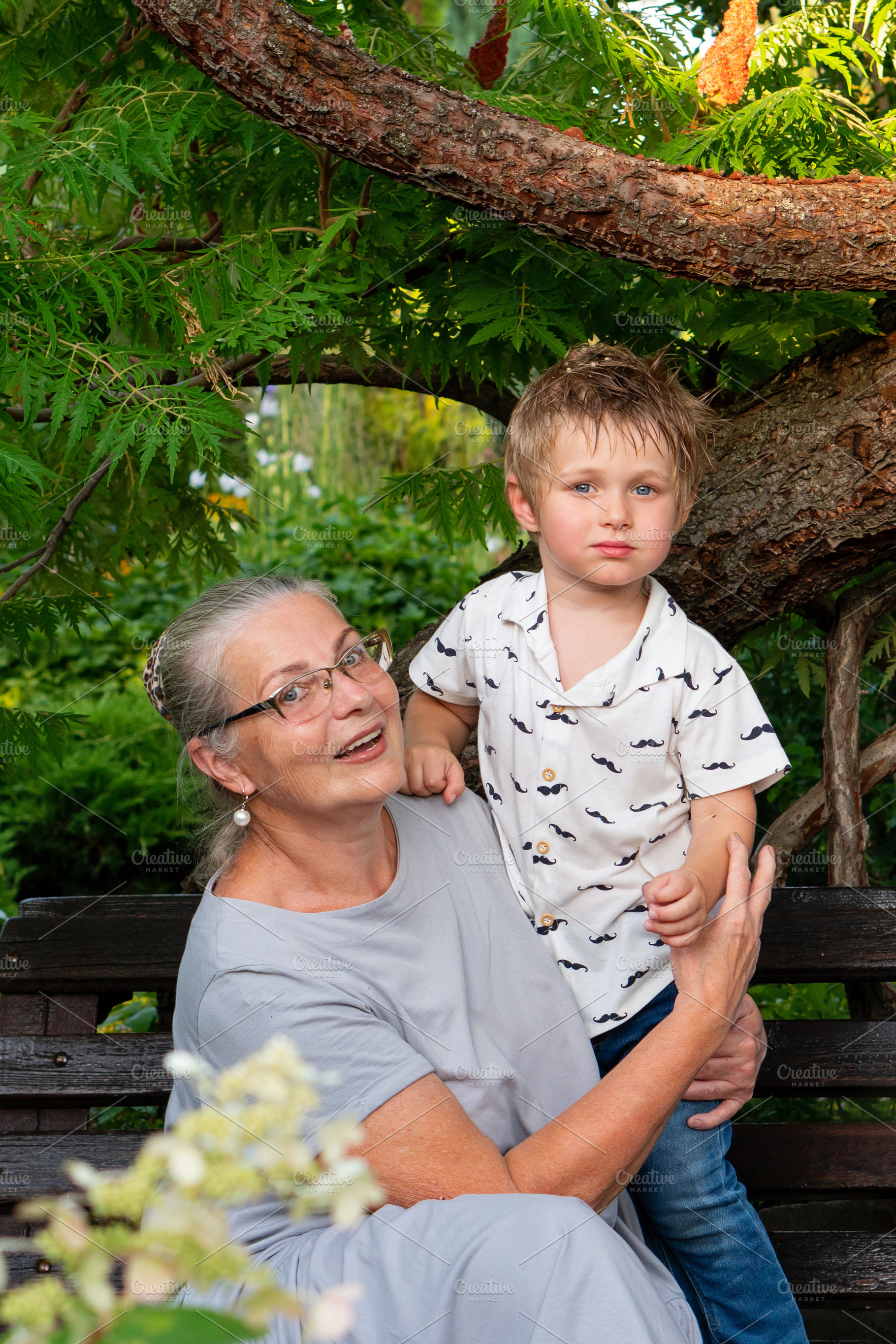 Grandmother holding young grandson, a Person Photo by Elena Vagengeim