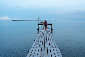 Sunrise on the wooden pier of Maupiti beach, French Polynesia, a Nature Photo by GoodGoods