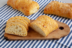 Homemade Cheese Ciabatta Bread on a Wooden Board, side view., a Food & Drink Photo by LiudmylaChuhunova