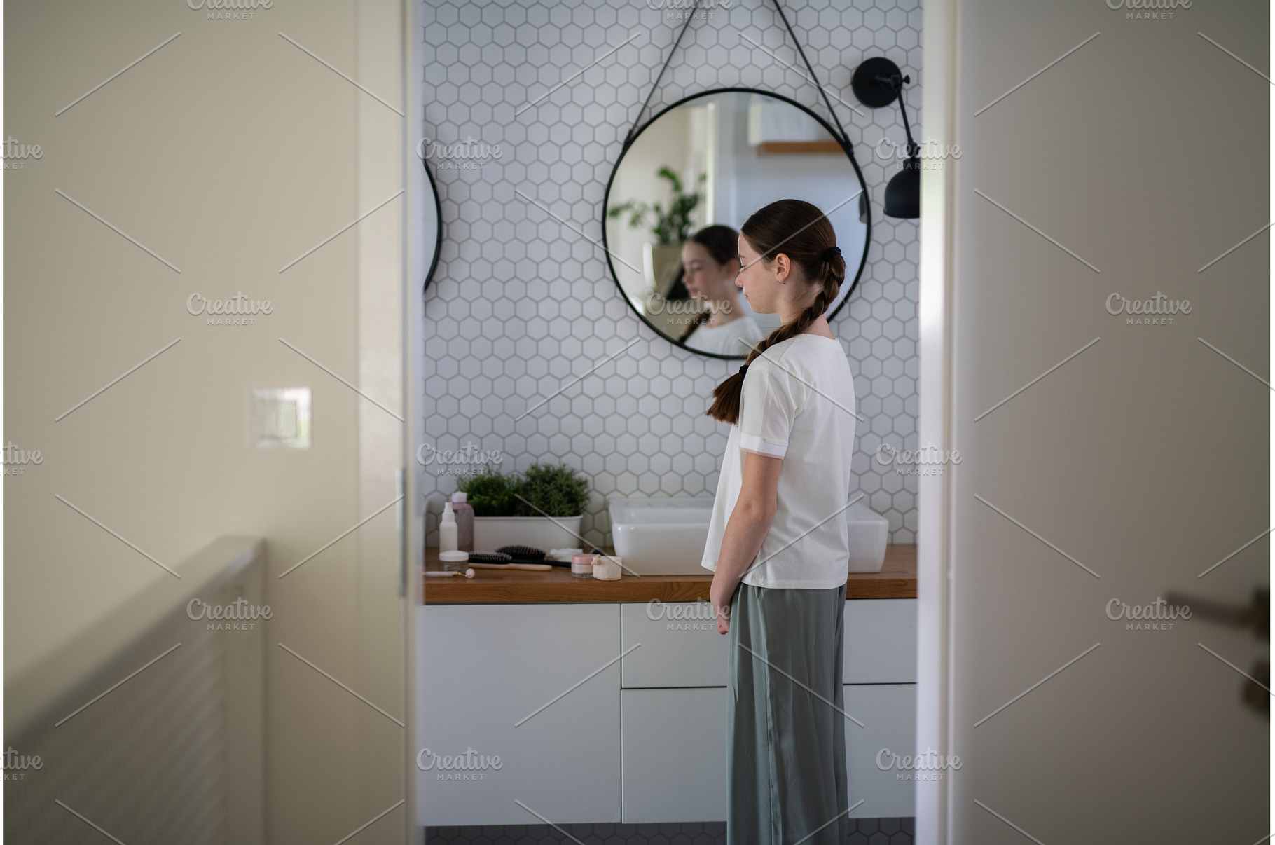 Teenage girl looking at herself in, a Person Photo by HalfPoint