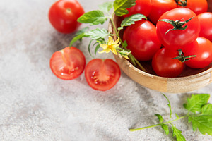 Fresh ripe cherry tomatoes with leaves and flower, a Food & Drink Photo by Olena Rudo