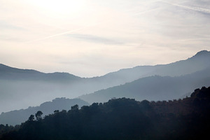Foggy landscape featuring mountain, fog, and cloud