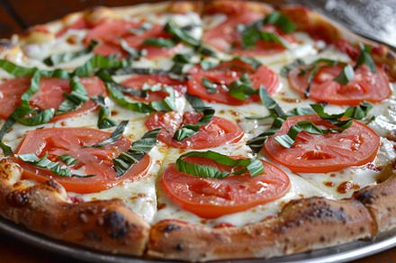 A detailed view of a margherita pizz, a Photo by Iftikhar Alam