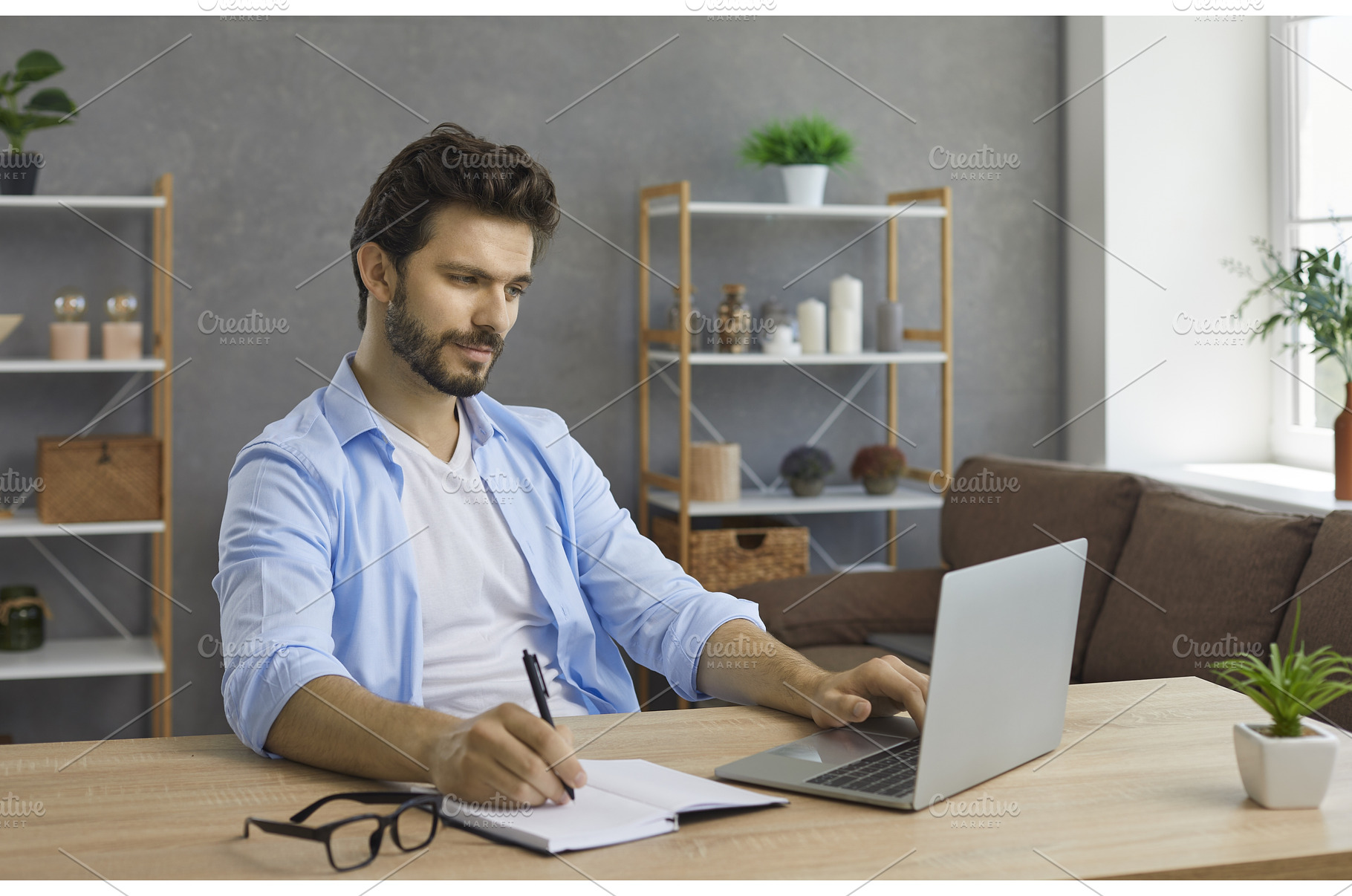 Young man sitting at desk with, a School & Education Photo by StudioRomantic