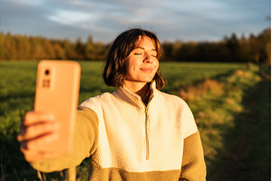 Young woman enjoying golden hour in, a Holiday Photo by AD Stock Images
