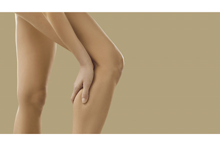 Woman suffer from pain in leg calf, a Person Photo by StudioRomantic