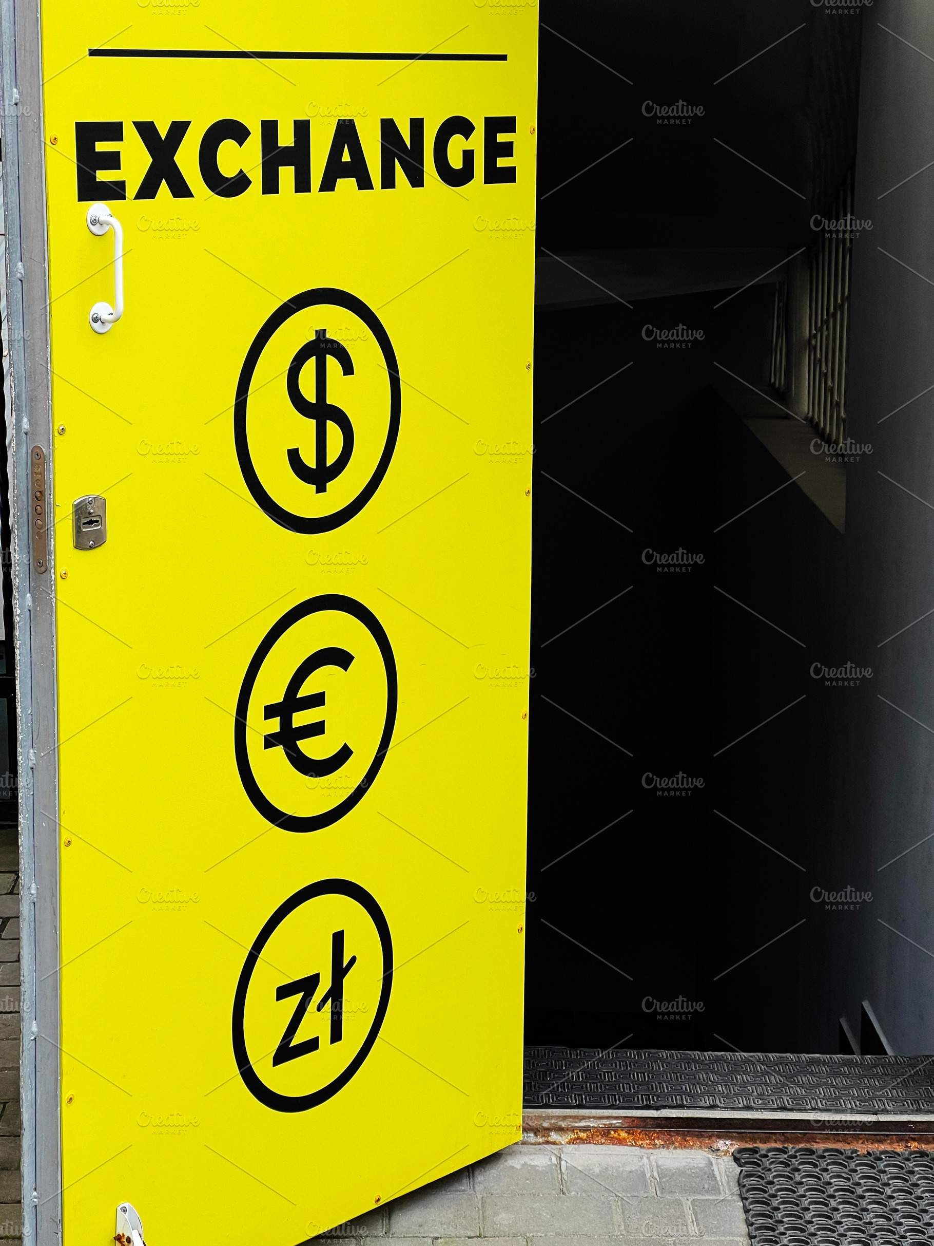 Yellow exchange sign with currency symbols displayed on a doorway, a Photo by AS photostudio