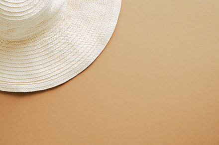 Flat lay straw hat on brown, a Holiday Photo by photoguns