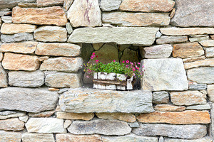 Stone wall decorated with flowers, an Architecture Photo by BOOCYS