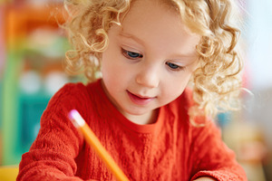 Child Drawing with Colored Pencils, a Person Photo by AlyaAnd