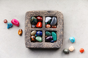 Colorful Tumbled Gemstones in Rustic Stone Tray on Light Surface, a Nature Photo by Natalia Klenova's Shop