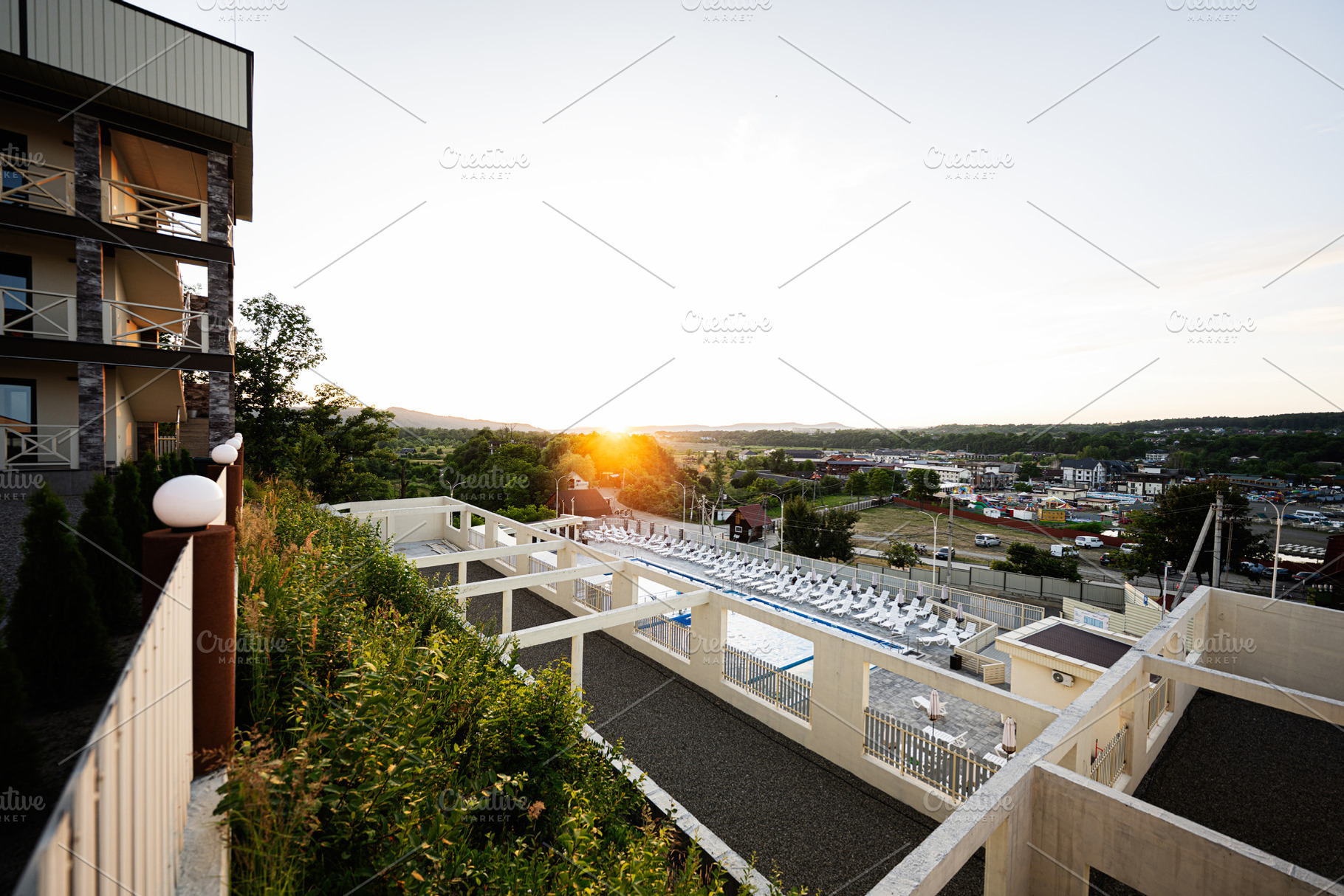 Scenic sunset view of a resort with lush greenery and modern architecture, a Photo by AS photostudio