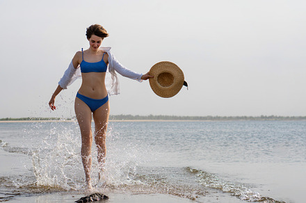 Girl in bikini walks on beach, a Person Photo by Elena Vagengeim