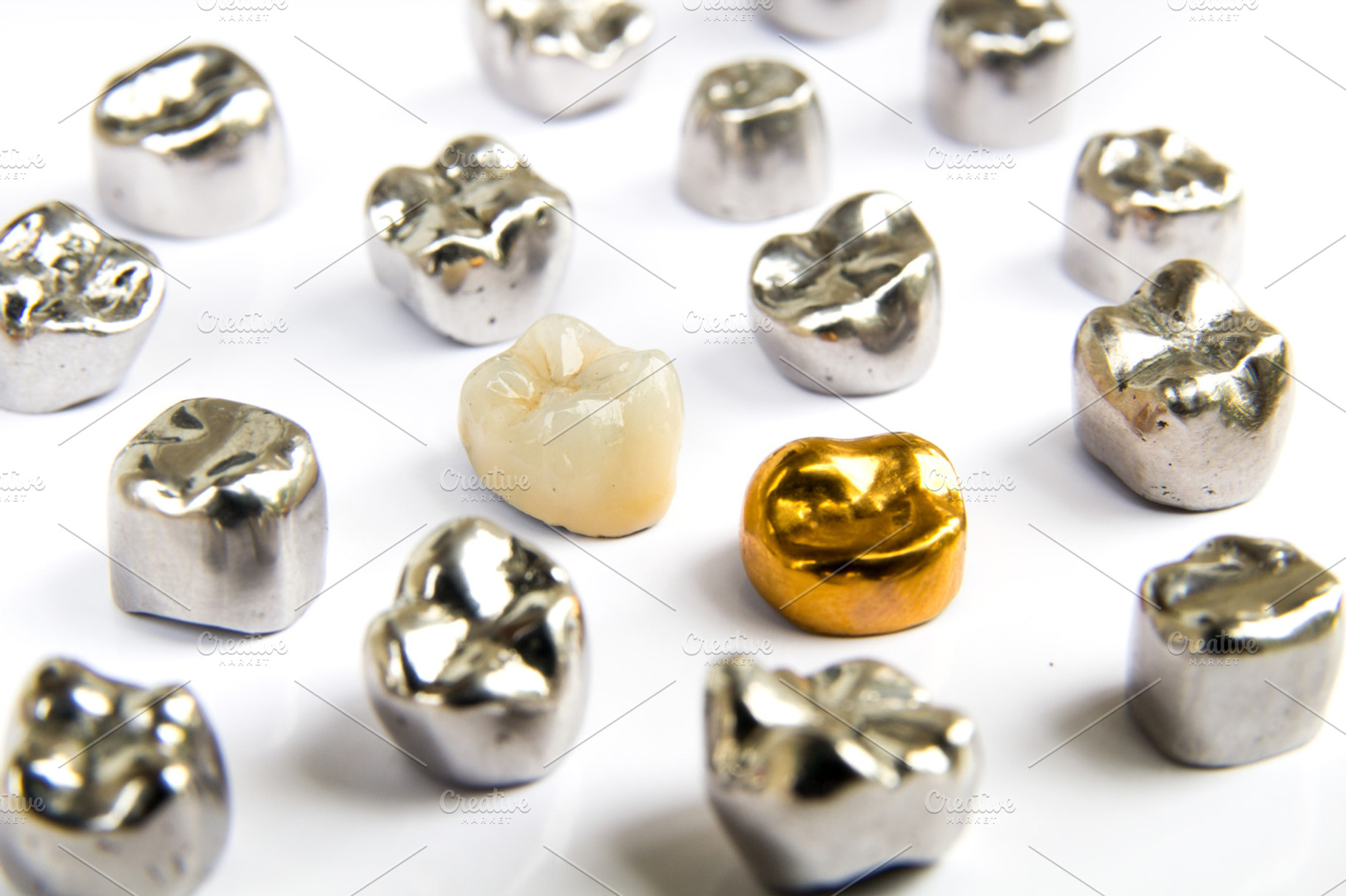Dental ceramic gold and metal tooth crowns on white background isolated, a Health & Medical Photo by Life For Photo