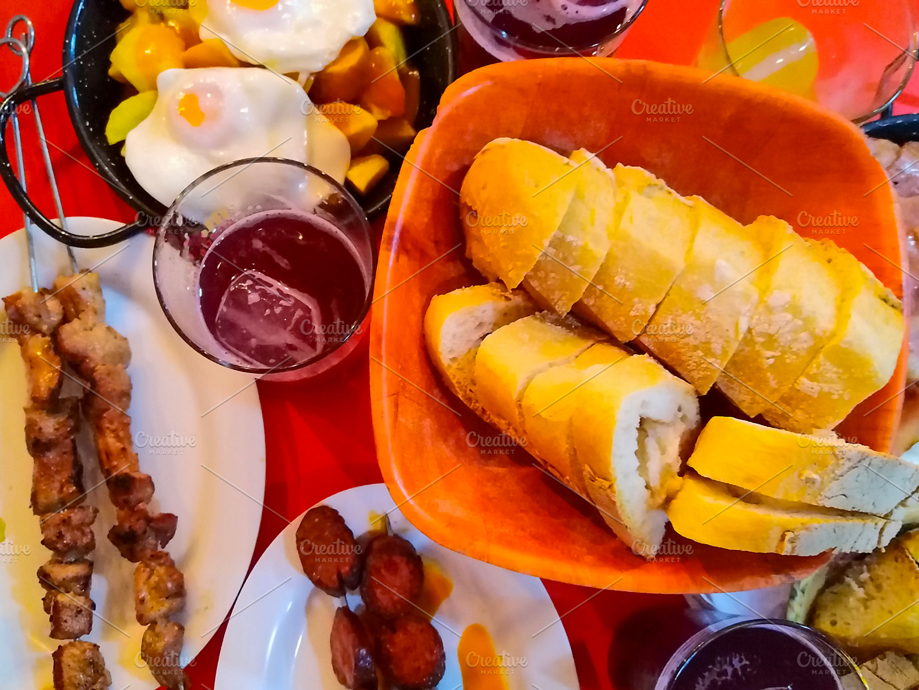 Assorted tapas and bread on colorful table, a Food & Drink Photo by DanFLCreativo