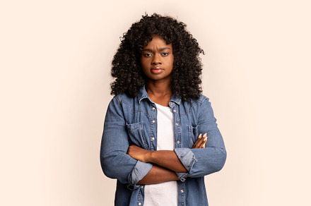 Beautiful african american millennial woman with arms crossed, a Background Photo by Prostock-Studio