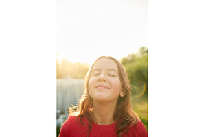 Girl enjoys the warmth of sunlight