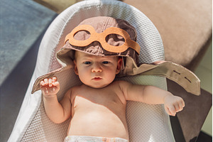 Baby wearing a pilot hat, a Person Photo by Elizaveta Galitskaya