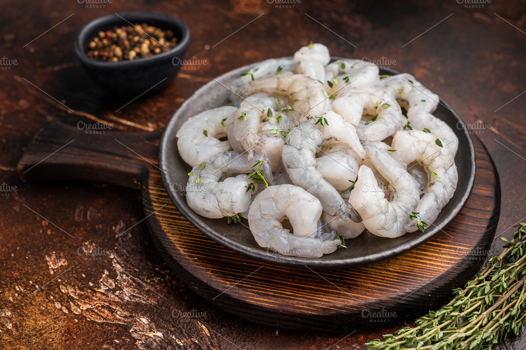 Raw peeled shrimp prawn in a cast iron skillet on a dark rustic, a Food & Drink Photo by composter-box@mail.ru