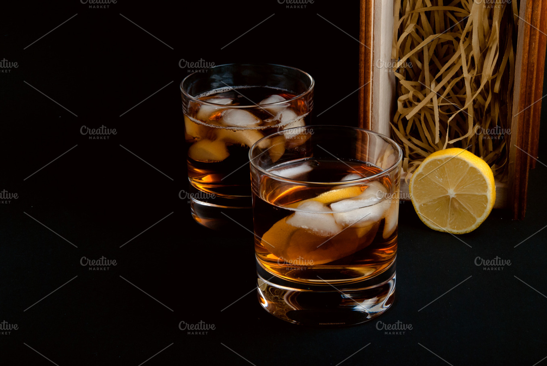 Whiskey glasses containing alcohol, ashtray, and background, a Food & Drink Photo by Bloor