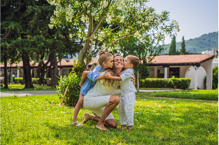 Happy family outdoors on the grass, a Person Photo by Elizaveta Galitskaya