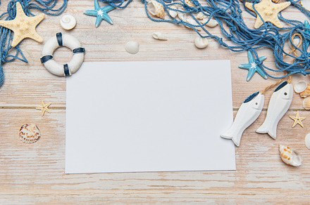 Nautical themed background with blank paper, seashells, starfish