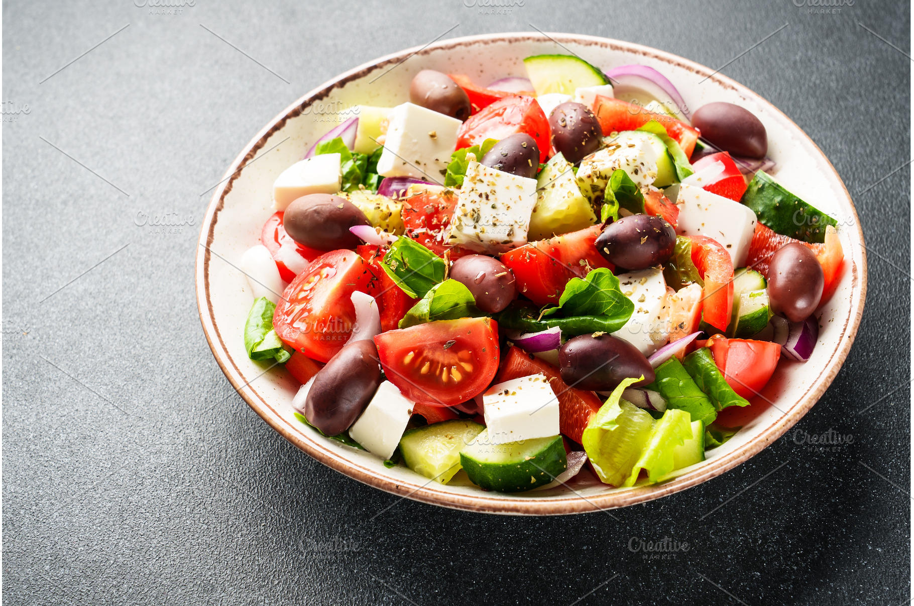 Greek salad in craft plate on black, a Food & Drink Photo by Nadia-nb