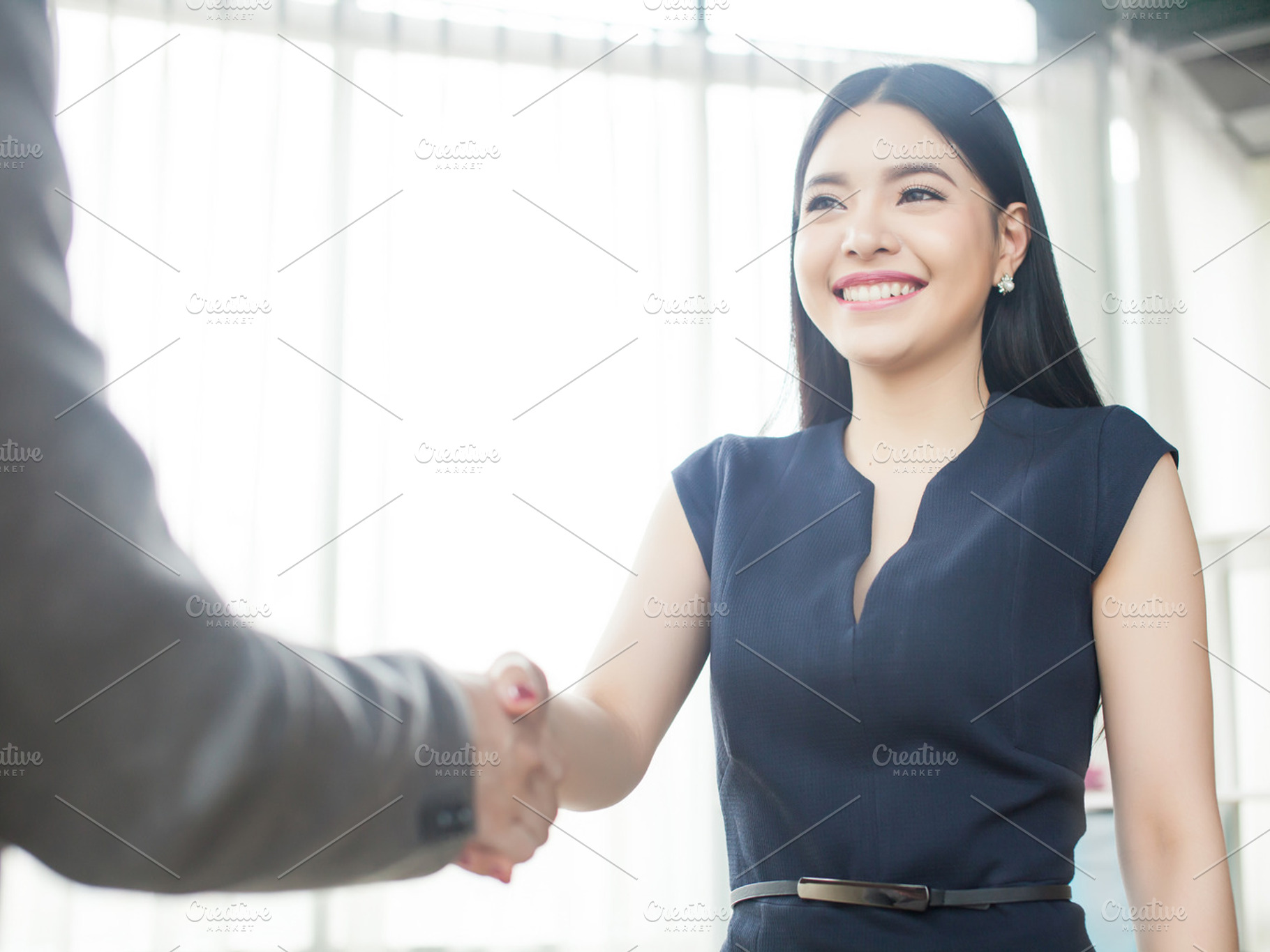 Smart and confident asian businesswoman smiling and shaking hands stock photo, a Business Photo by Twinster Photo