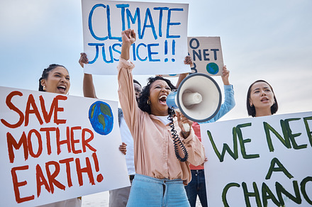 Black woman, climate change and megaphone protest with crowd protesting for environment and change. Save earth sign, group activism and angry people shouting on bullhorn to stop planet pollution., a Photo by Peopleimages.com