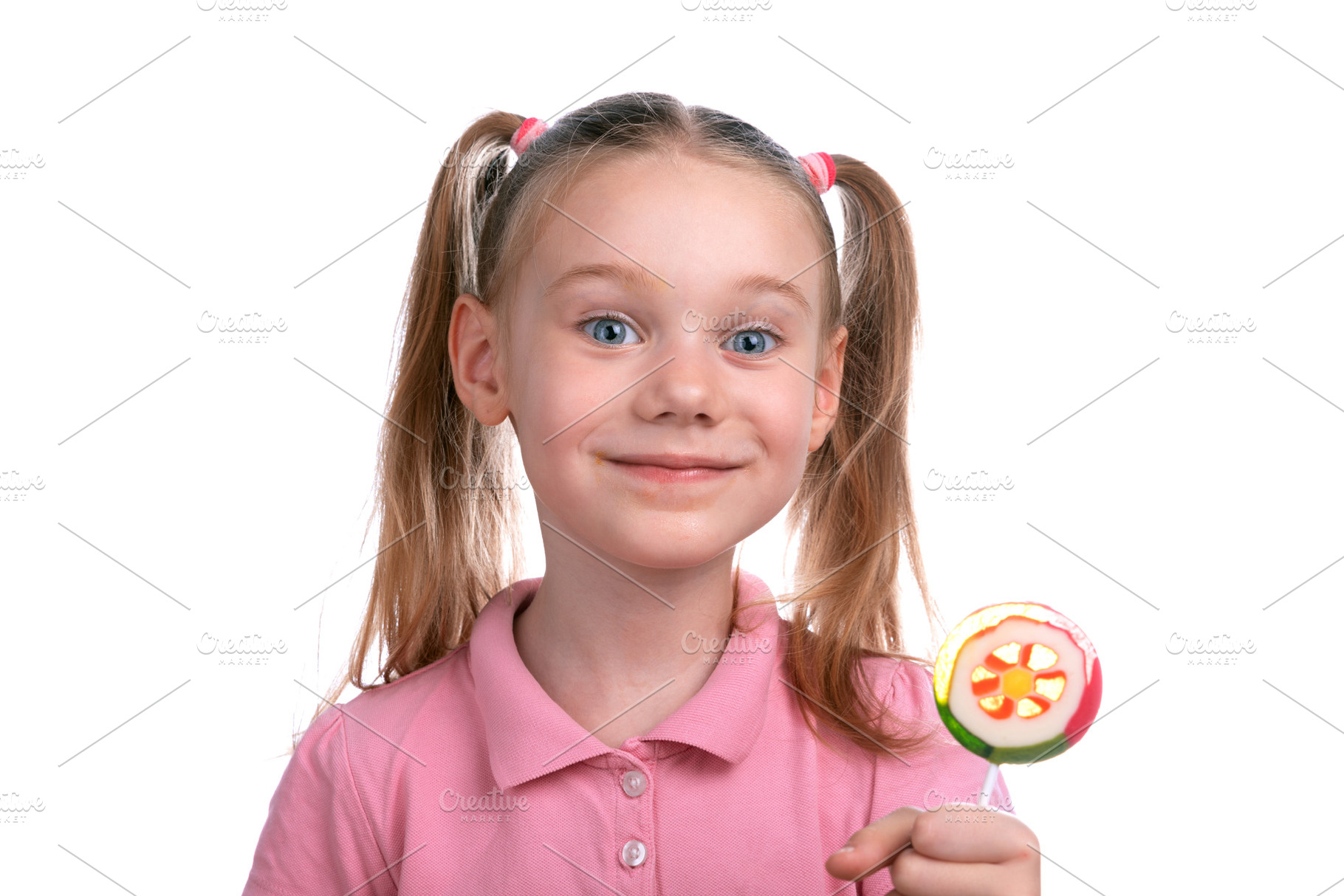 Cheerful young girl in a pink shirt smiling while holding a colo, a Person Photo by Ales Munt