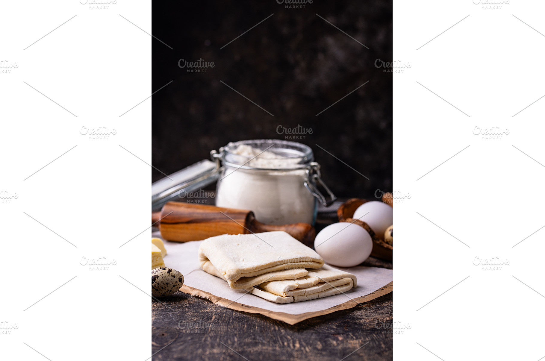 Raw puff pastry dough with baking, a Food & Drink Photo by Yulia Furman