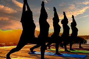 Diverse group practicing yoga at nature, a Health & Medical Photo by DanFLCreativo