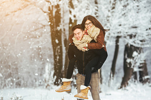 Happy couple playful together in snow park containing amazing, snow, and