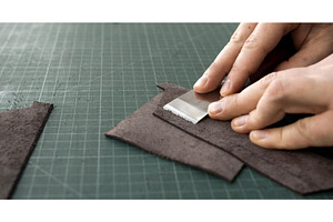 Skiving leather edge with precision, a Person Photo by volodymyrshtun13795