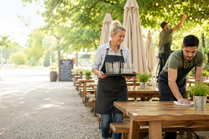Outdoor restaurant staff setting up, a Photo by Dvoevnore photos